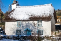 Thatched cottage in Georgeham with snow