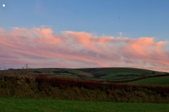 Dramatic clouds lit by the setting sun over Exmoor near Challacombe